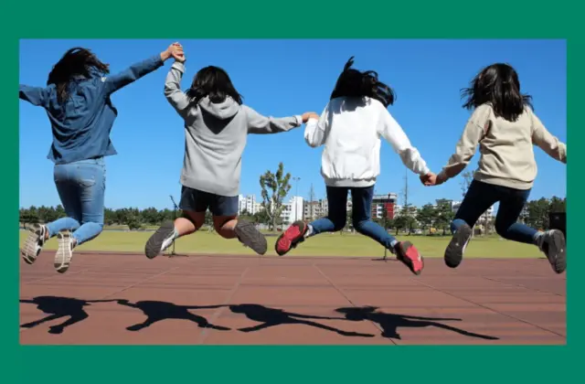 leaping school children in the air