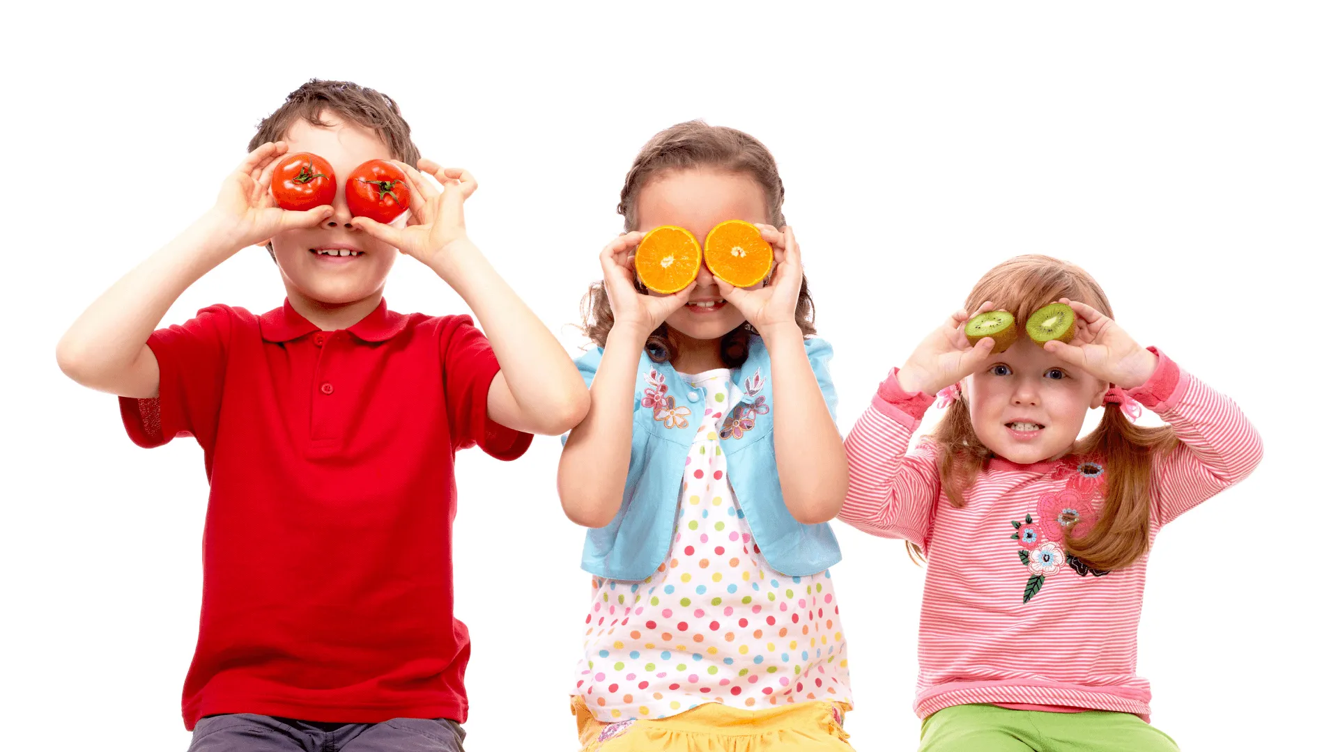 smiling kids with fruit in their eyes