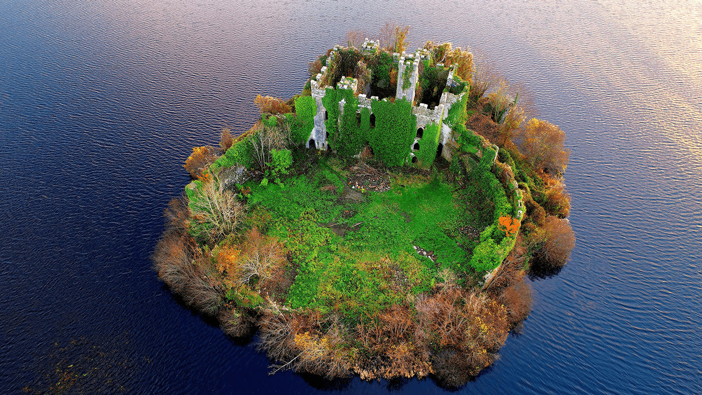 Aerial of the McDermott's Castle and a national monument in county Roscommon surrounded by the tranquil sea